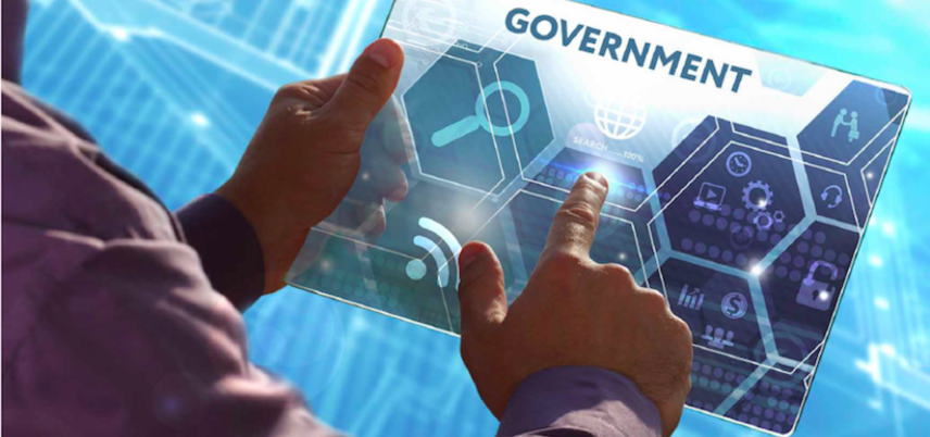 Man's hands holding tablet with Government technology icons